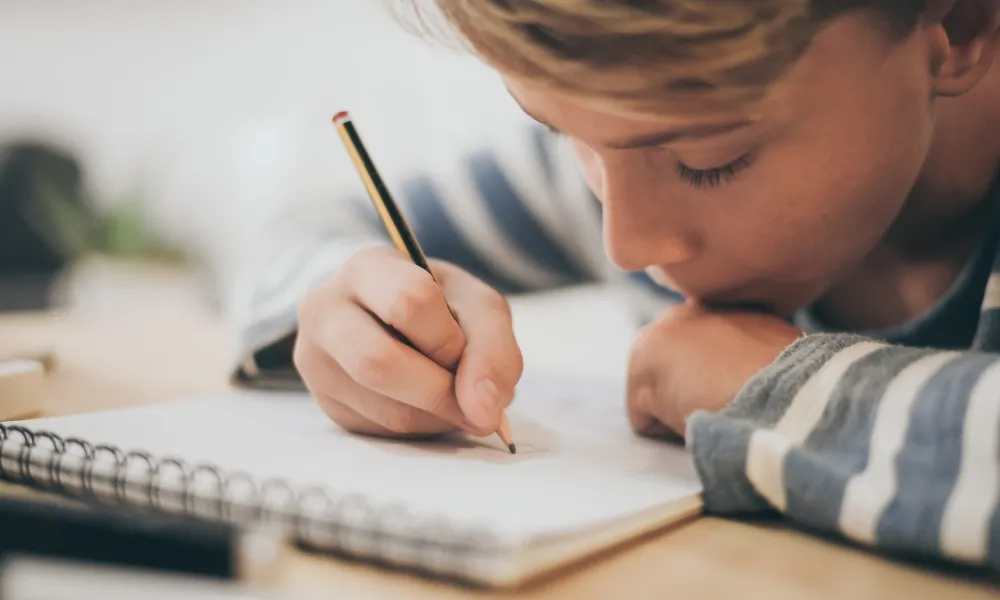 Student writing in a notebook