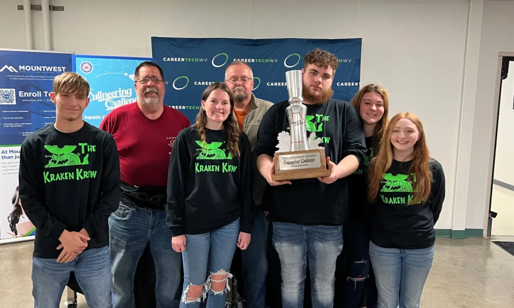 Students at the November 14, 2023 MCTEC event showing off their trophy.