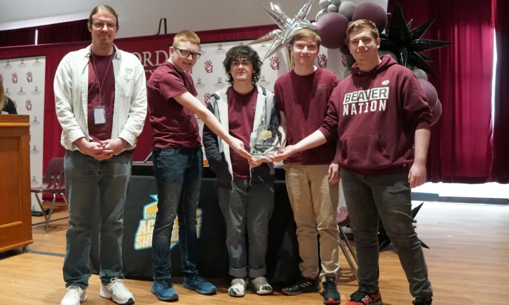 Bluefield High School students posing with a first-place trophy.