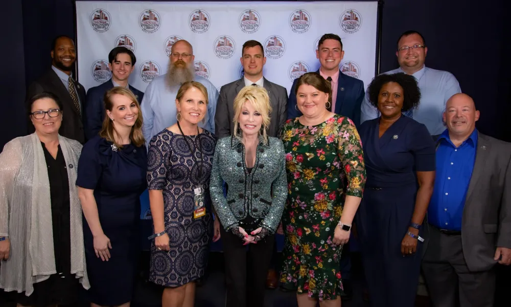 The WVDE communications team poses with Dolly Parton for Imagination Library