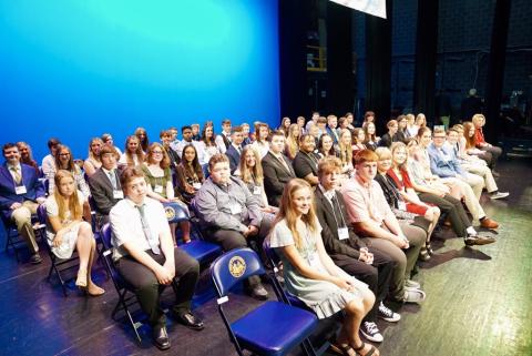 Group of Golden Horseshoe winners sit on the stage at the Knighting Ceremony