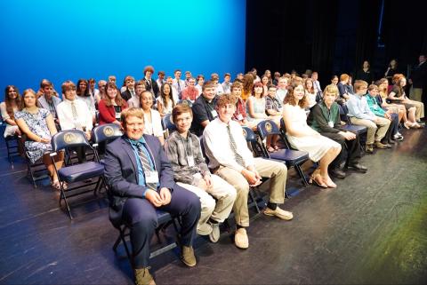 Group of Golden Horseshoe winners sit on the stage at the Knighting Ceremony