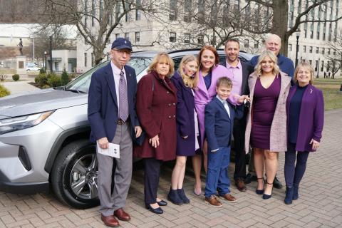 Amber Nichols (Teacher of the Year) and Family pictured in front of A car