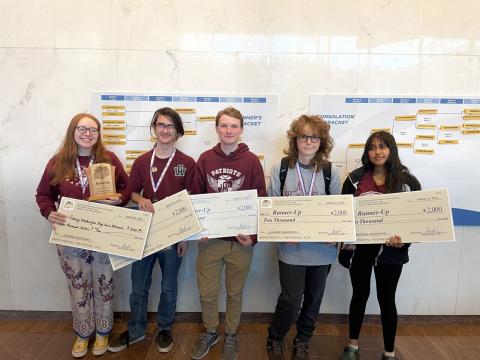 George Washington team holding awards.