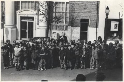 Rockefeller gathered with children outside of a library on Temple Street in Hinton, WV.