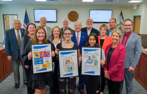 Pictured are students holding posters and posing for a photo with members of the West Virginia Board of Education 