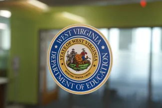 WV Department of Education Seal on a glass door.