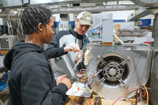 People working on HVAC wiring.