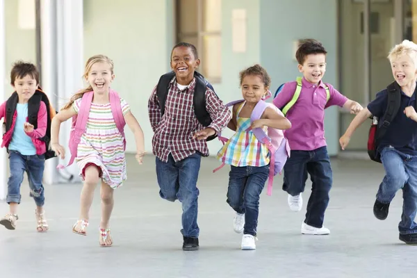 children running towards camera with smiles on their faces.